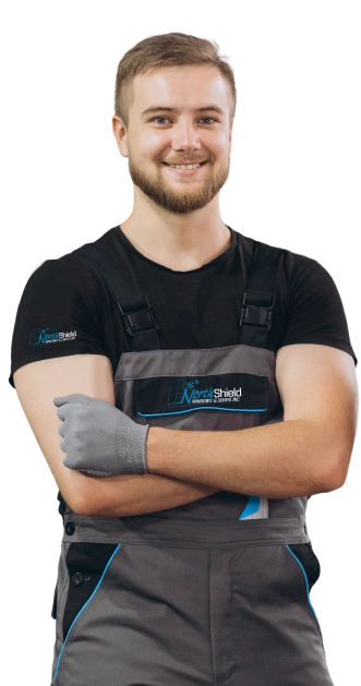 northshield man wearing overalls stands with arms crossed
